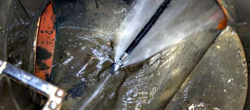Farnham Drains24 engineer performing high-pressure water jetting to clear a stubborn drain blockage