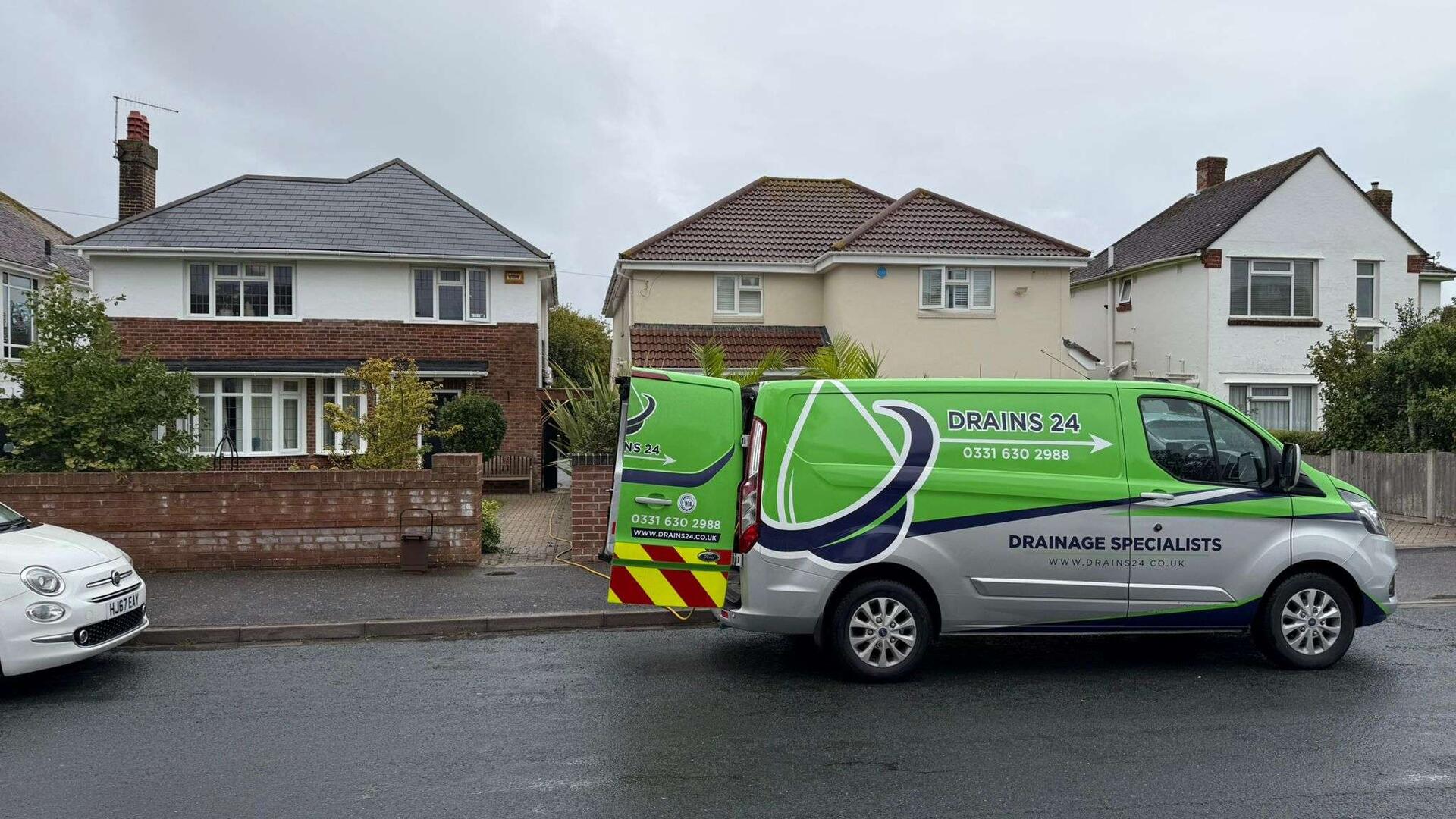 Farnham Drains24 engineer performing winter drain maintenance and clearing outdoor gully